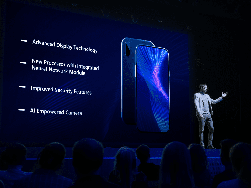 image of audio visual man on stage with large screen behind him