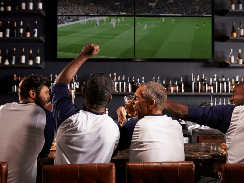 image of men sitting watching game at<br />
sports bar